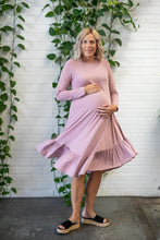 Load image into Gallery viewer, pregnant lady standing infront of an indoor plant twirling in a pink long sleeve dress
