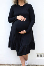 Load image into Gallery viewer, pregnant lady in a stylish black maternity dress
