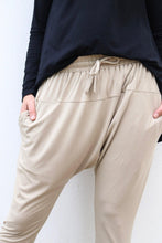 Load image into Gallery viewer, front on view of neutral colour pants and hands in pockets against a white wall
